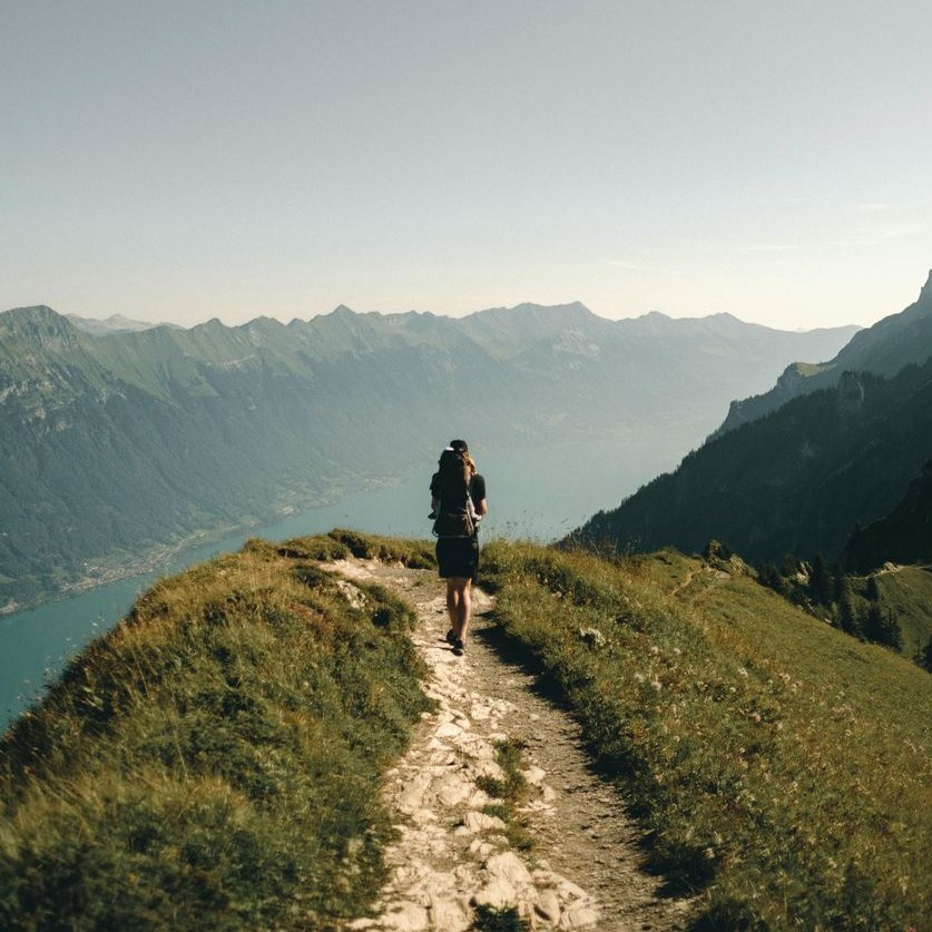 A hiker standing on a mountain ridge