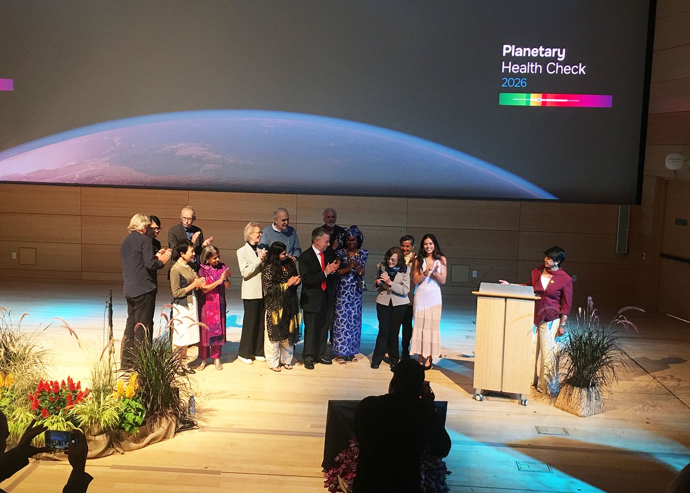 The Planetary Guardians standing together on stage under a Planetary Health Check 2026 screen